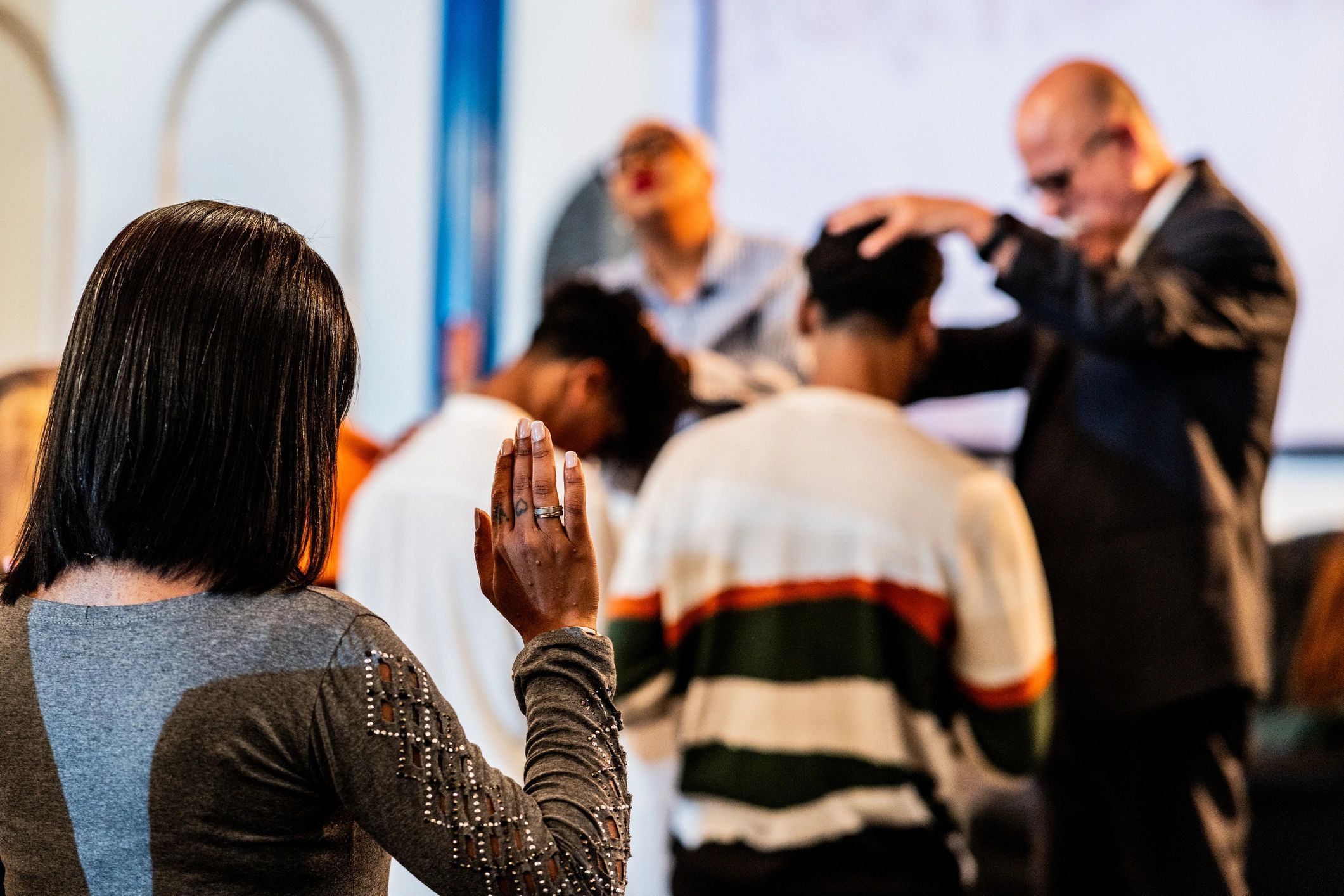 Woman praying in a church setting