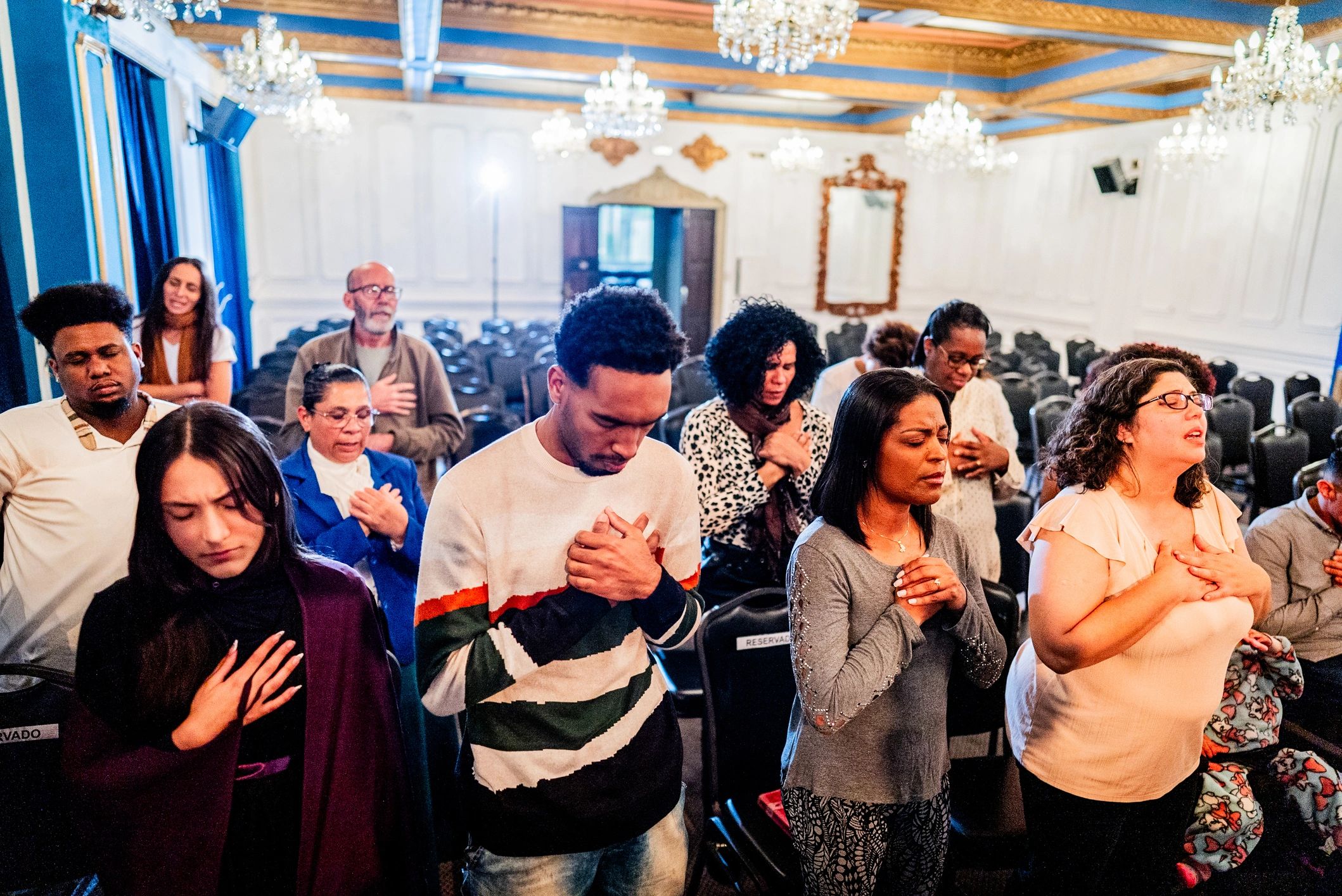 Group of worshippers praying together in church