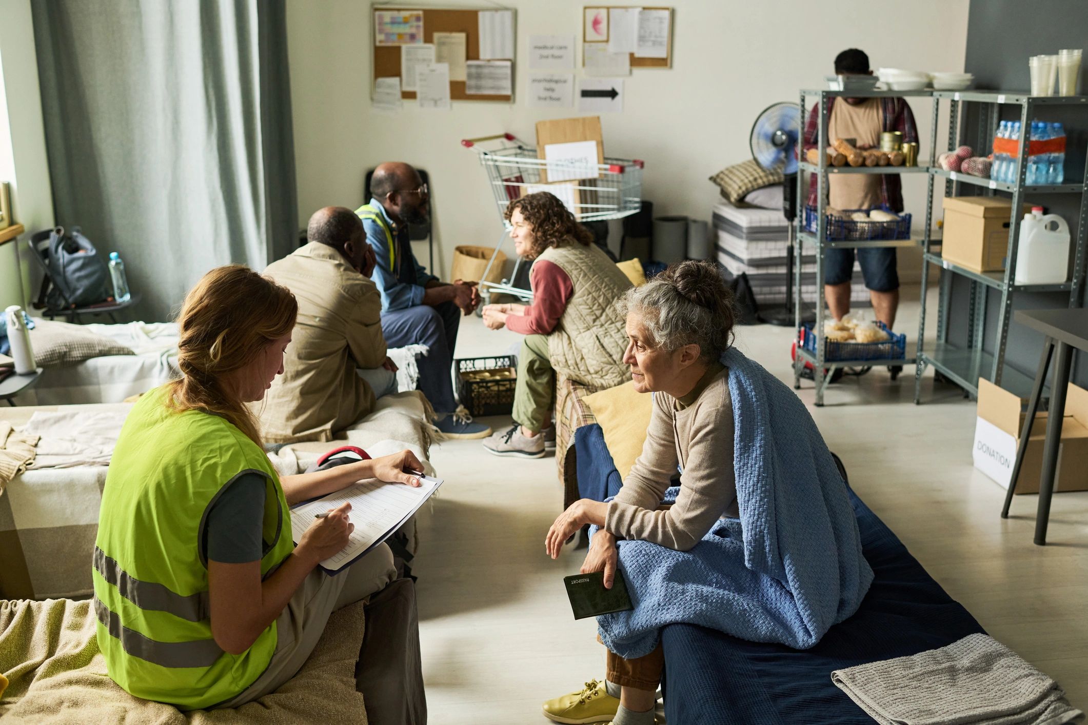 Volunteer assisting a woman in a community support center